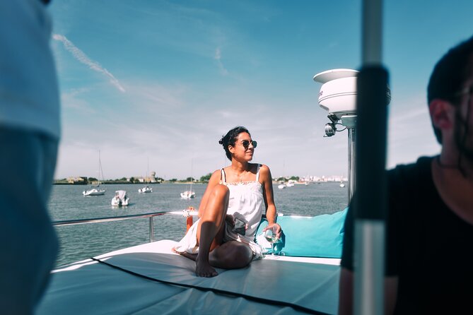 4 Hours Private Tour with Dives in Catamaran in Lisbon - Returning toward Belém: beaches, a relaxed pace, and 25 de Abril Bridge views