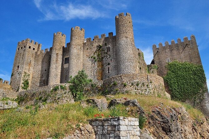 Excursion from Lisbon to Fátima Grutas Nazaré and Óbidos - Nazaré on the Atlantic: cliffs, waves, and a town you can actually enjoy