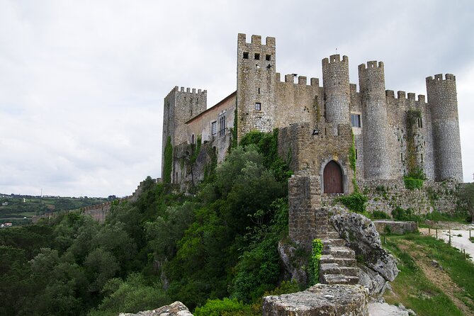 Fatima, Batalha, Nazaré and Óbidos: Private Full Day Tour - Óbidos: walking medieval lanes from inside a castle wall