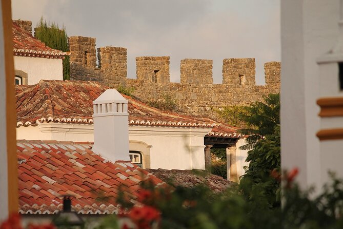 Fátima, Batalha, Nazaré and Óbidos Small Group Tour from Lisbon - Óbidos: cobblestones, white-and-flower streets, and a ginjinha finale