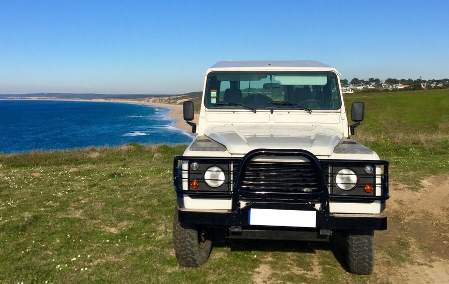 From Lisbon or Sesimbra: 4x4 Tour to Cape Espichel - Sesimbra Castle on a green hill: culture before the coastline hits