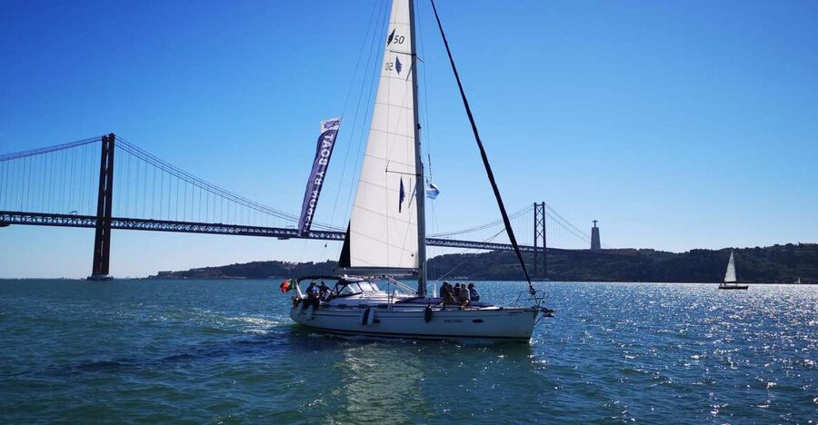 Lisbon: 2-Hour Sailing Yacht Cruise & Guided Tour w/2 drinks - Ponte 25 de Abril: a suspension-bridge view with big drama