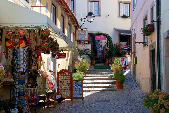 Lisbon: Fatima, Nazare, Obidos, mira de aire cave private tour - Óbidos castle walls: medieval Portugal with modern shopping
