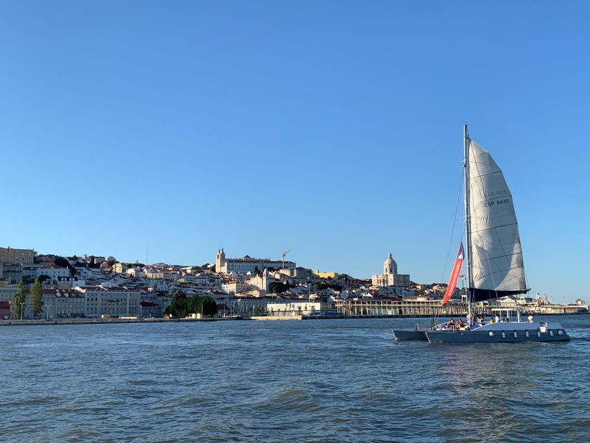Lisbon: Private Catamaran Charter for up to 18-People - Turning Toward Lisbon City: 25 de Abril Bridge From Underneath