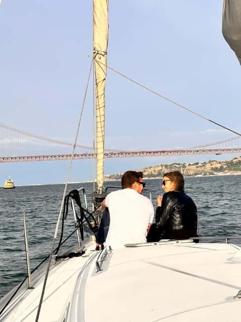 Lisbon: Romantic Cruise with Wine & Portuguese Tapas - Bridges, markets, and factory streets: Lisbon from a moving timeline