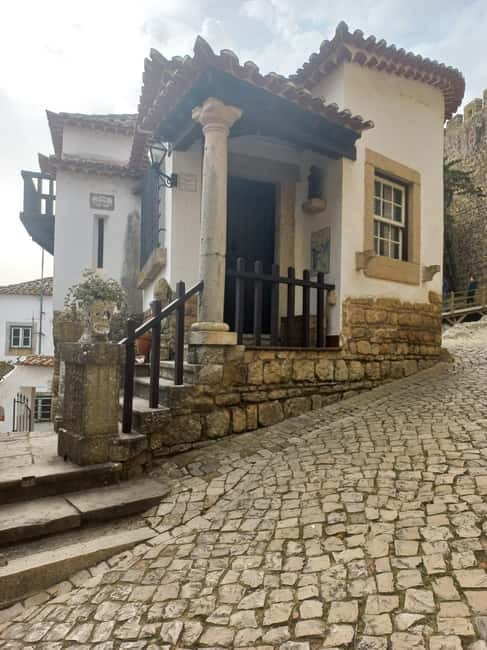 Lisbon: Transfer to Porto with Obidos and Nazare - Nazaré dunes and beach time for photos, people, and seafood breaks